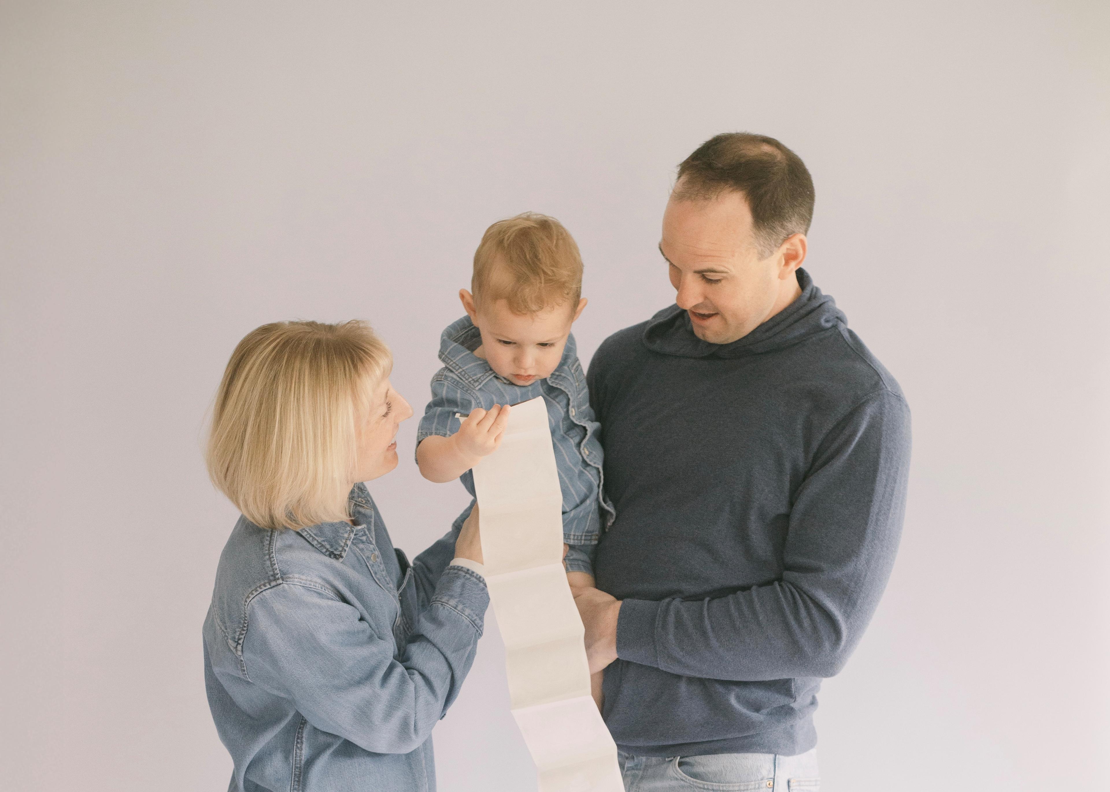 Alex and Liz Schelling with their first child, holding an ultrasound photo
